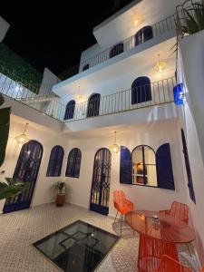 a patio with a table and chairs in front of a building at Riad house Lyabaïana,piscine climatisation, hammam, vue mer in Tangier