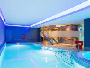 a swimming pool with a slide in a hotel at Novotel Edinburgh Centre in Edinburgh