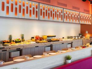 a buffet line with many plates of food at ibis Styles Barcelona Sant Joan Despi in Sant Joan Despí