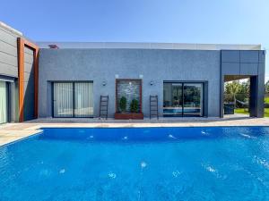 a house with a swimming pool in front of a house at Villa Ramona in Marrakech +57 photos