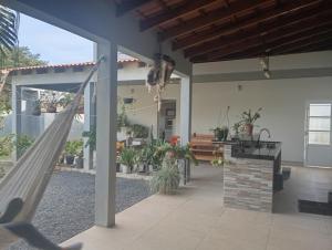 a porch with a hammock in a house at Quarto casal in Itaqui