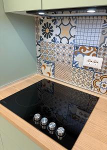 a drawer with a stove in a kitchen with tiles at Selena's Apartament's in Durrës