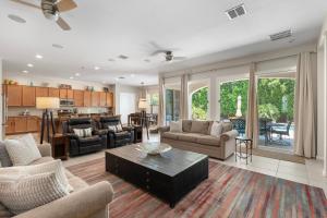 a living room with a couch and a table at Luxury Queen Creek Oasis w Pool & Spa in Queen Creek