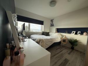 a bedroom with a bed and a desk in it at Villa med 4 soverom, sjøutsikt og hage ved lokal badestrand in Bergen