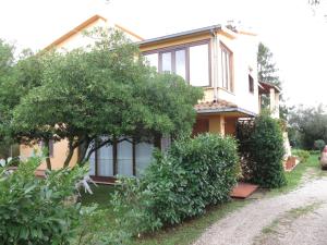a house with trees and bushes in front of it at AL MANDORLO Casa Vacanze in Viterbo