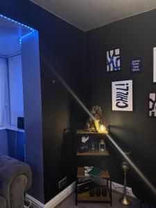 a living room with a blue light on a wall at A Star Living in Liversedge +6 photos