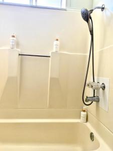 a shower in a bathroom with two bottles on the wall at Cozy Coastal by Beaches & Redwoods in McKinleyville +10 photos