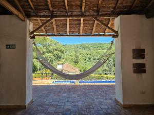 a hammock hanging from a roof in a courtyard at Aires de Encanto in Curití