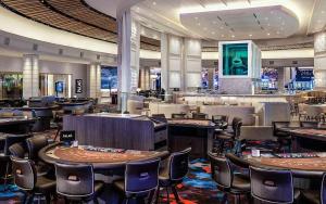 a restaurant with tables and chairs in a casino at Palms Place Hotel Mountain View with Open Balcony in Las Vegas