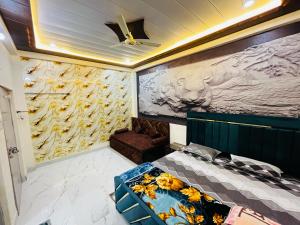 a room with a bed and a painting on the wall at Ram Bhawan HomeStay in Vrindāvan +77 photos