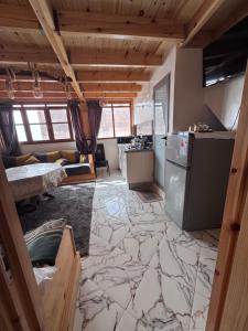 a kitchen and living room with a large marble floor at Rooftop apartments in Taghazout +12 photos
