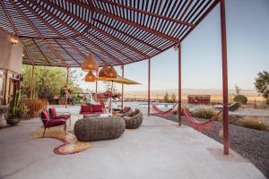 a patio with chairs and a table with a view at Espacio El Sol in La Tirana