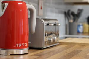 a red toaster sitting on top of a kitchen counter at Kings Corner in Warrenpoint +32 photos
