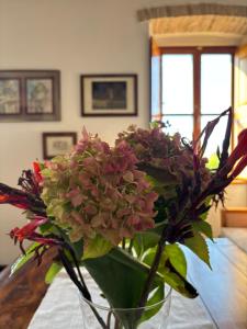 a vase filled with pink flowers on a table at Villa Anica Dubrovnik - luxurious with a sea view in Dubrovnik