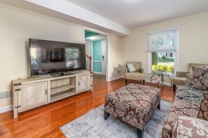 a living room with a large flat screen tv at Space of Peace in Charlotte