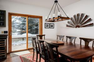 a dining room with a wooden table and chairs at Southfork Retreat in Big Sky +45 photos