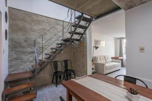 a living room with a staircase and a table at Hermoso duplex en Palermo in Montevideo