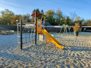 a playground with a slide in the sand at La Petite Maison du Park in Boofzheim