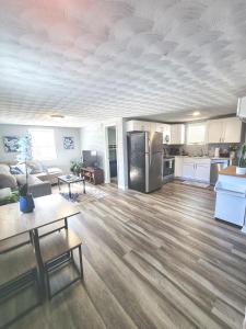 an empty living room with a kitchen and a living room at Cozy 2 Bdrm Cottage King bed in Portsmouth +6 photos