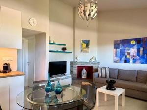 a living room with a glass table with vases on it at Sani Villa Miramare in Sani Beach