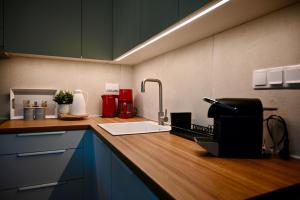 a kitchen with a counter top with a sink at Sani Villa Miramare in Sani Beach +19 photos