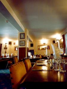 a dining room with a long table and chairs at The Douglas Hotel in Langholm