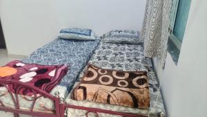 a bed with two pillows on it in a room at Nilkanth Bunglows in Garudeshwar
