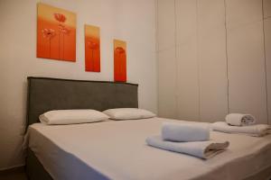 a bedroom with a bed with two towels on it at Sani Villa Miramare in Sani Beach