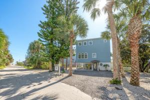 a building with palm trees in front of it at The Sand Euro - 4BR, 3Full & 1Half BA in Historic Summer Haven near beaches and Matanzas Inlet in Summer Haven
