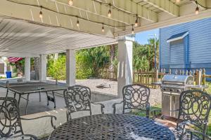 a patio with a table and chairs and a grill at The Sand Euro - 4BR, 3Full & 1Half BA in Historic Summer Haven near beaches and Matanzas Inlet in Summer Haven +59 photos