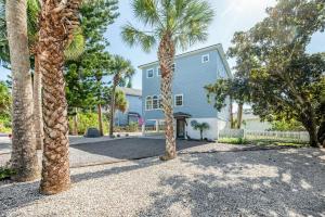 a house with palm trees in front of it at The Sand Euro - 4BR, 3Full & 1Half BA in Historic Summer Haven near beaches and Matanzas Inlet in Summer Haven