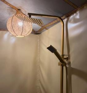 a lamp in a room with a wall at Sahara dream luxury in Merzouga