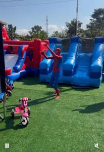 a woman standing in front of an inflatable playground at Signature Resort Hotel Jinja in Jinja