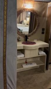 a bathroom with a sink and a mirror at Sahara dream luxury in Merzouga