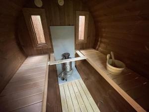an inside view of a wooden cabin with a bucket at Black Cabin Veluwe - Wellness in het bos - Airco & Sauna in Putten +31 photos