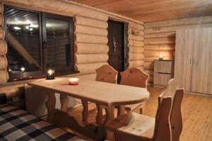 a wooden dining room with a table and chairs at Гостьовий дім Секвойя in Verkhniy Bystryy +38 photos