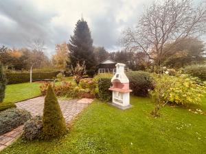 a garden with a bird house in the grass at Charmantes Ferienhaus an der Mosel mit Garten, Weinbergblick & Privatparkplatz in Zeltingen-Rachtig