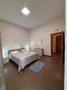 a bedroom with a large bed in a room at La Fenice Central in Reggio Calabria