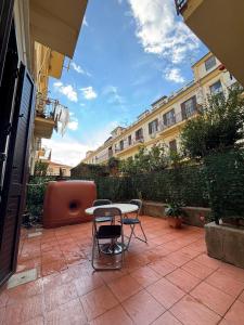 a patio with a table and chairs and buildings at La Fenice Central in Reggio Calabria +51 photos