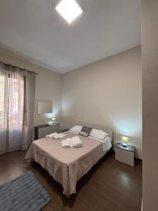 a bedroom with a bed with two towels on it at La Fenice Central in Reggio Calabria