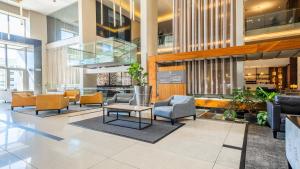 a lobby with chairs and tables in a building at CENTURY CLUB - Luxury Apartment Hotels in Cape Town