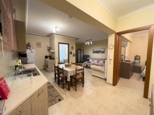 a kitchen and living room with a table and chairs at Fotini's Holiday Beach Home in Dhíkella