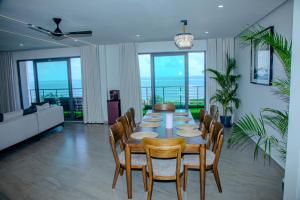 a dining room with a table and chairs at Semo's Aqua luxury 6 bedrooms Penthouse sea views in Mombasa