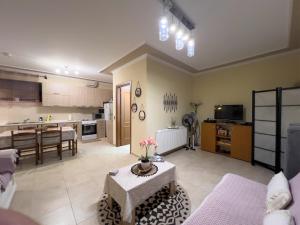 a living room with a table and a kitchen at Fotini's Holiday Beach Home in Dhíkella
