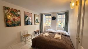 a bedroom with a bed and two windows at Latin Quater 1 - 4 in Copenhagen