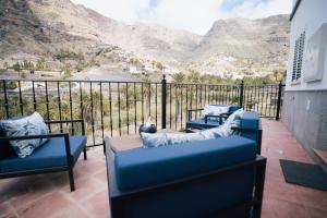 a balcony with couches and a view of a mountain at Petit Suite in Valle Gran Rey