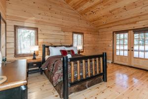 a bedroom with a bed in a log cabin at Kawagama Shoreline in Algonquin Highlands