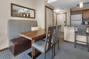 a kitchen and dining room with a table and chairs at Mountain View Escape with open hot tub, Views!! in Canmore +23 photos