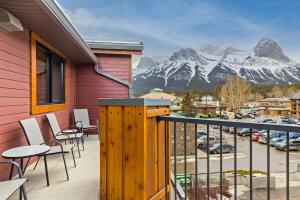a balcony with chairs and a view of a mountain at RidgeView Loft - Top Floor 2 Bed 2 Bath, Amazing Views in Canmore
