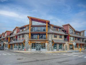 a large building on the corner of a street at RidgeView Loft - Top Floor 2 Bed 2 Bath, Amazing Views in Canmore +28 photos